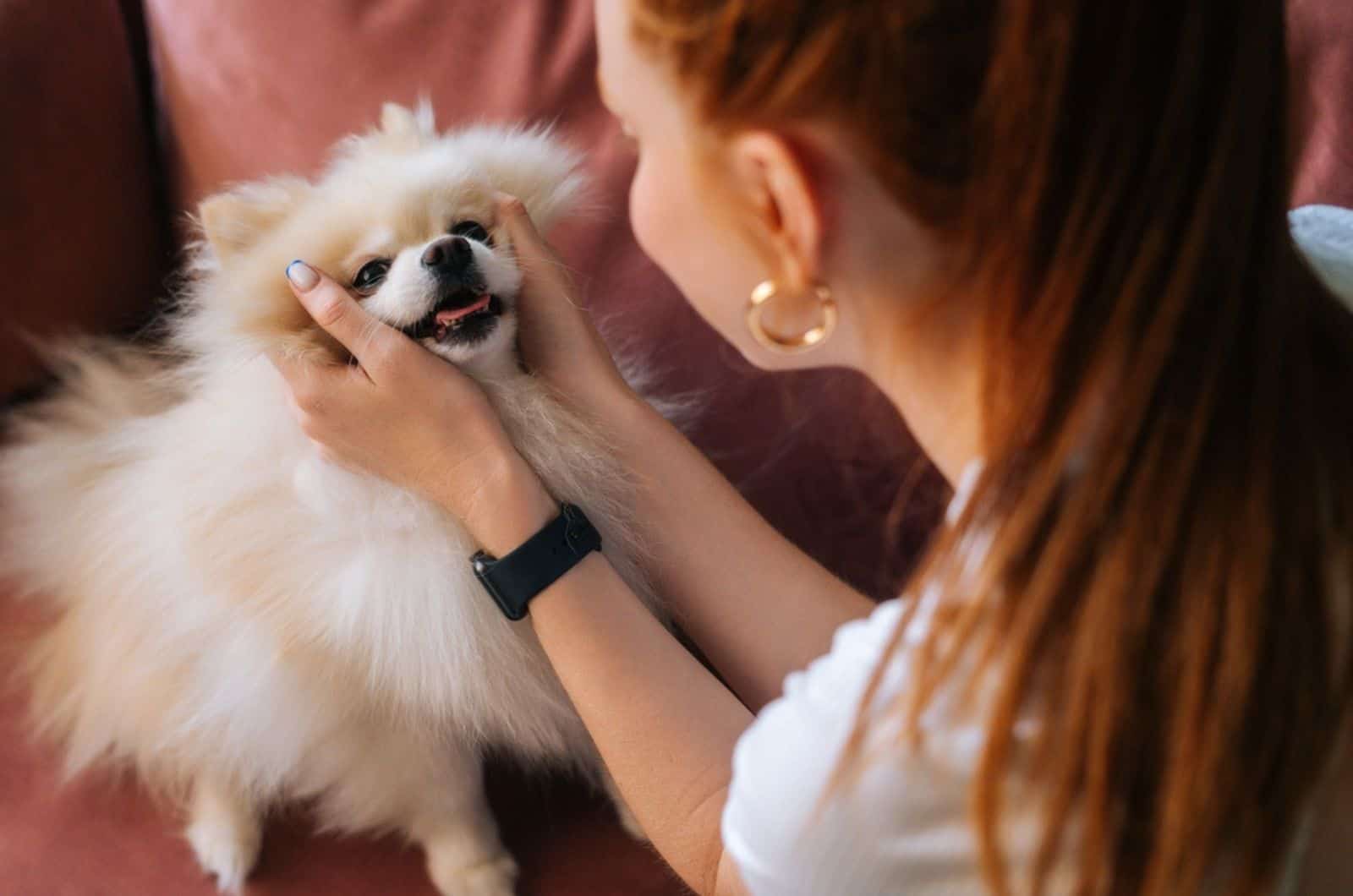 mujer jugando con su perro en casa